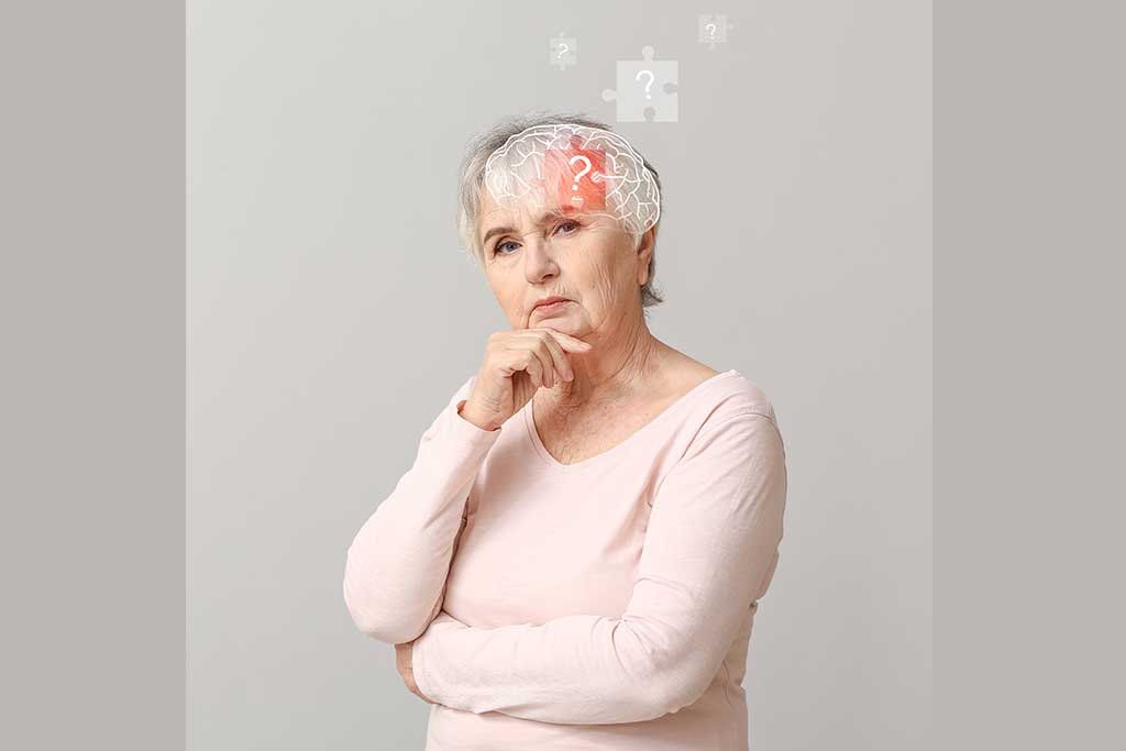 Elderly woman suffering from mental disability on grey background